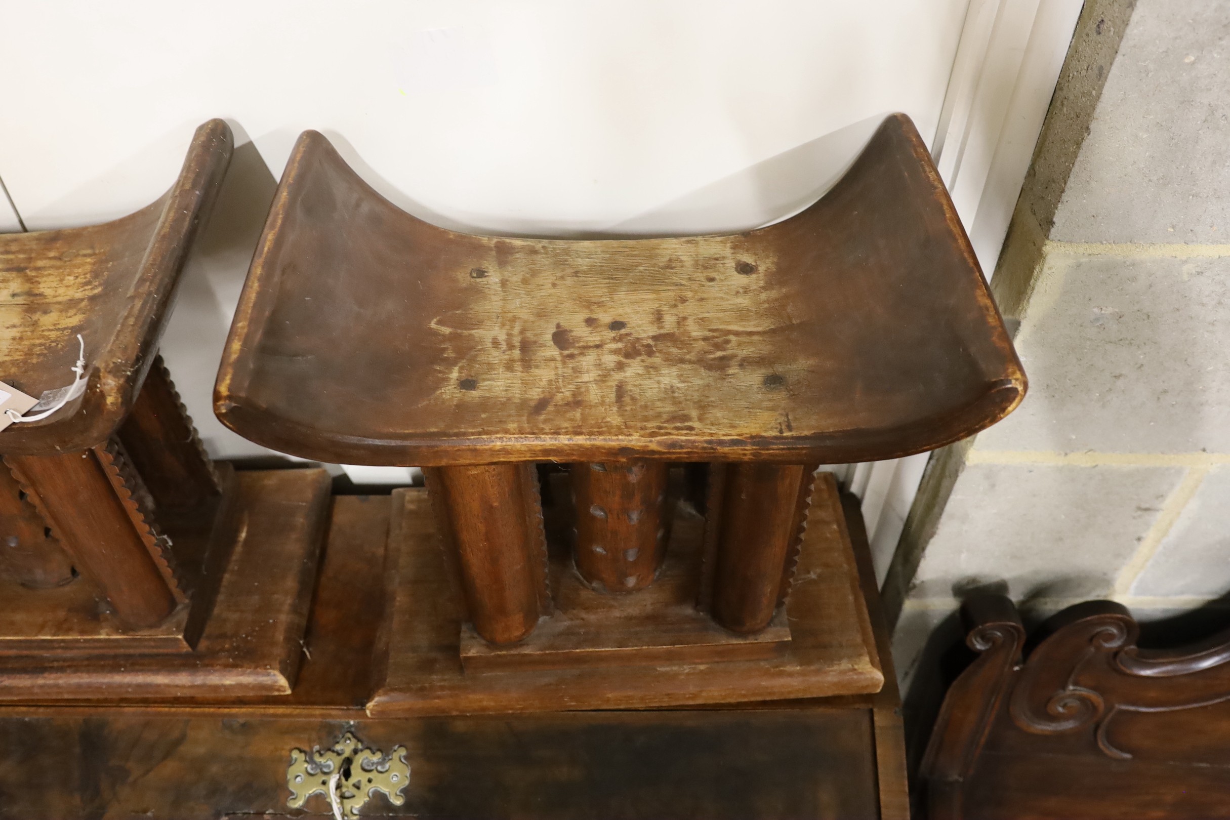 A pair of African carved hardwood stools, width 46cm, depth 29cm, height 43cm